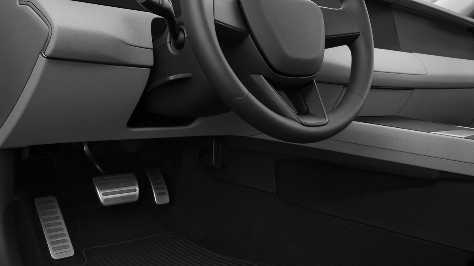 Black-and-white view of a car's steering wheel and steering column from the driver's footwell